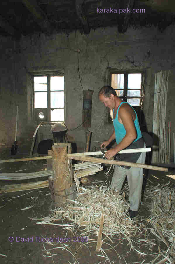 Shaving the bent poles to make the finished uyiqs